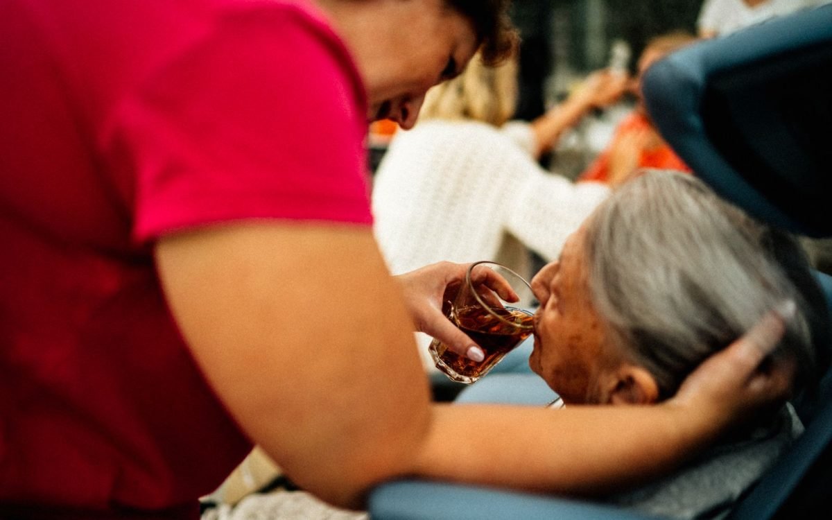 Caregiver spending time with a senior client, noticing changes in her wellbeing